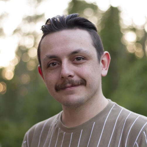 Ivan outdoors smiling, headshot